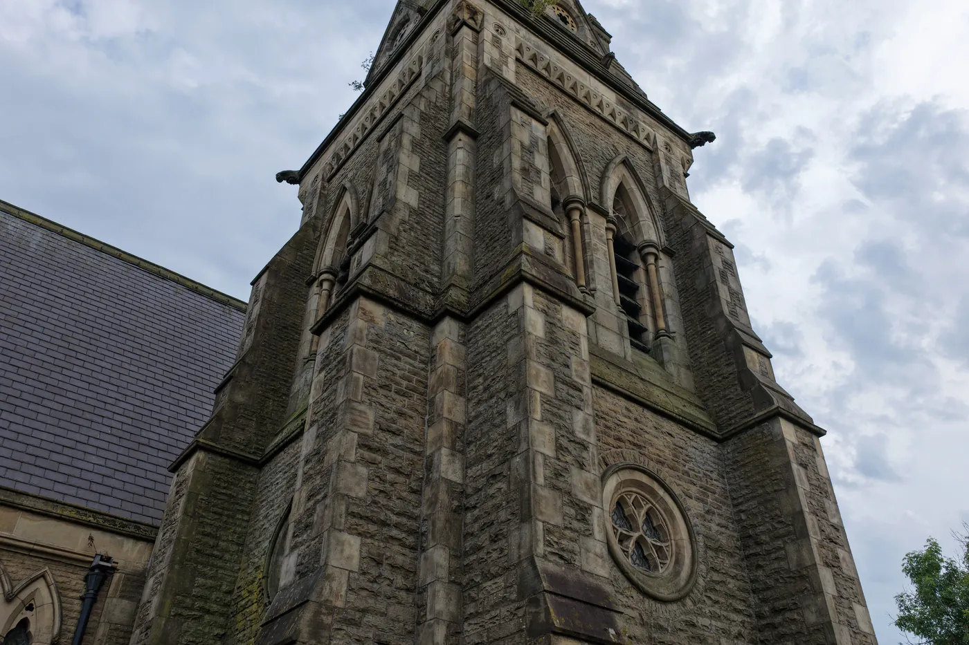 The tower of St Thomas from directly beneath, showing the rose window and louvred belfry