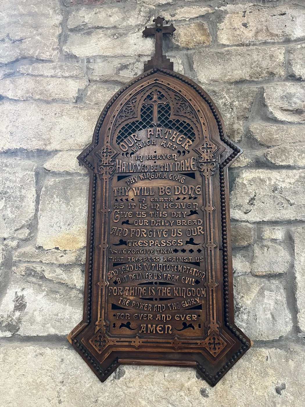 Historic memorial plaque mounted on the church stonework