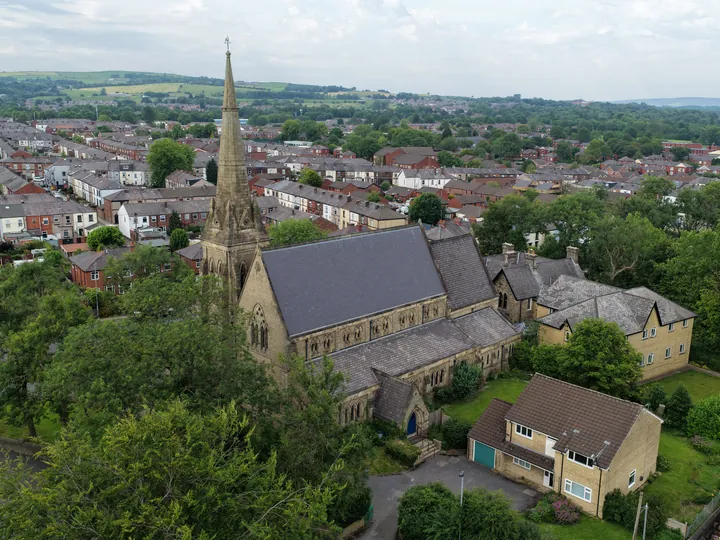 St Thomas seen from the air amid terraced streets, with the Lancashire moors on the horizon