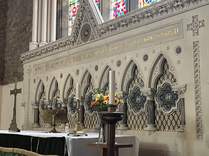 Carved stone reredos and candles at the high altar