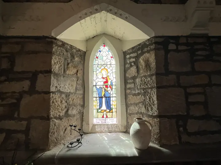 Single coloured lancet window set in rough stone