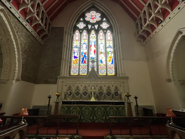 The high altar seen beneath the red and timber chancel roof