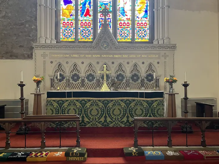 Frontal view of altar, candles and stone reredos