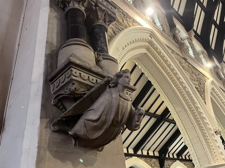 Carved angel corbel supporting an interior arch