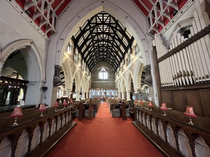 Symmetrical view down the red-carpeted nave toward the altar