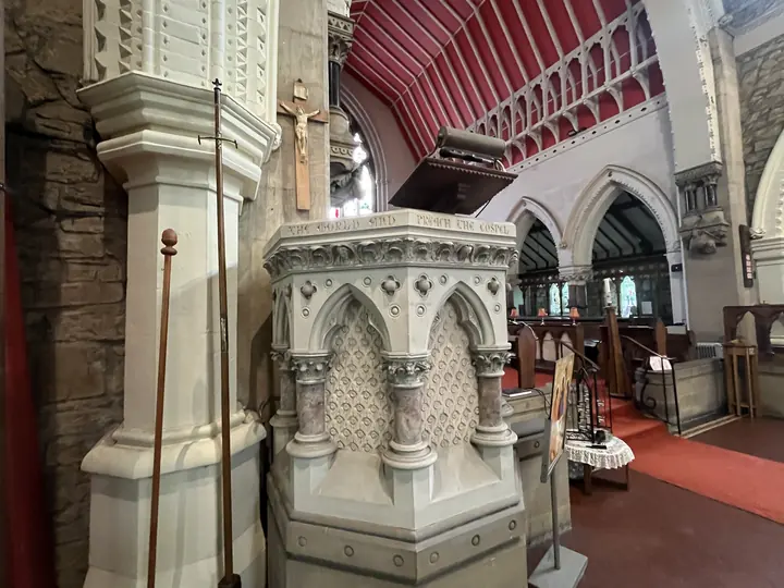 Stone pulpit framed by the church arcades