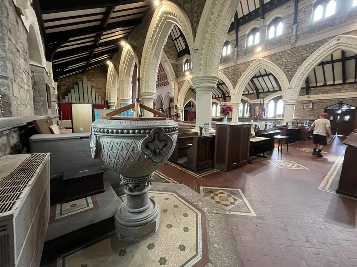 Font in the foreground of the light-filled nave