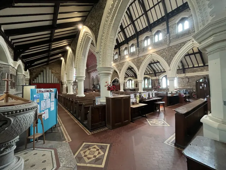 Broad view across the font, arcades and nave